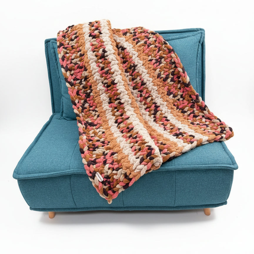 Photo of brown, pink, tan throw on chair