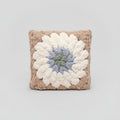 A photo of a granny square pillow