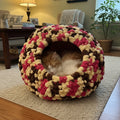 A photo of a large multicolor cat cave with an AI generated cat and background of a living room