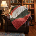 An olive, cream and burnt orange blankie on an AI generated chair and background