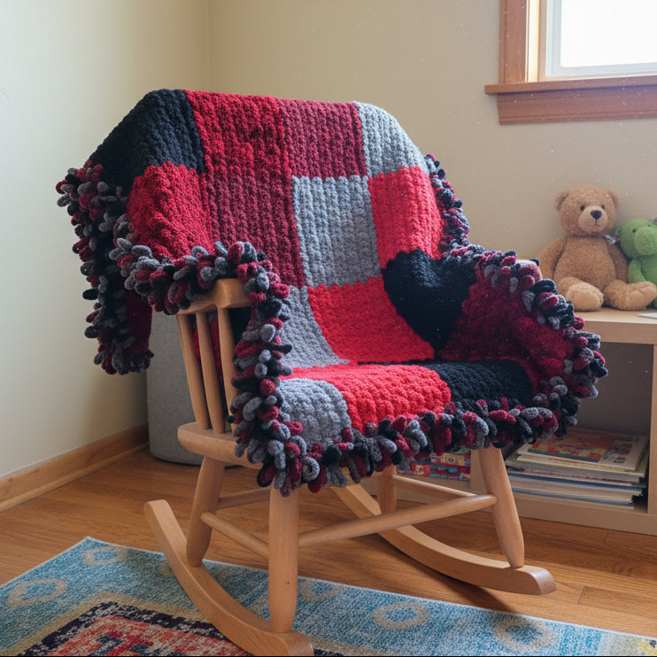 A photo of a red and black patchwork blankie draped over a rocking chair