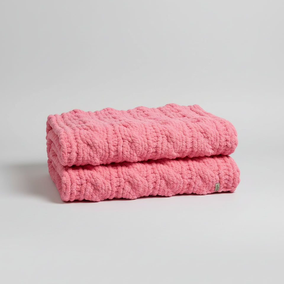 Photo of pink twisted cable baby blanket