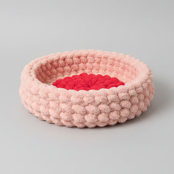 A photo of a pink pet bed