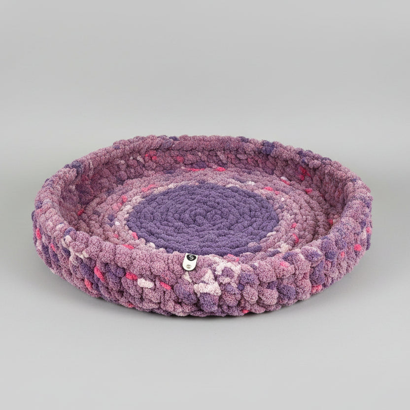A photo of a purple speckled pet bed