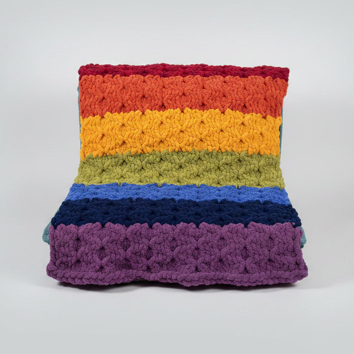 A photo of a textured pattern rainbow blanket