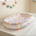AI generated photo of unicorn colored bassinet mat on changing table
