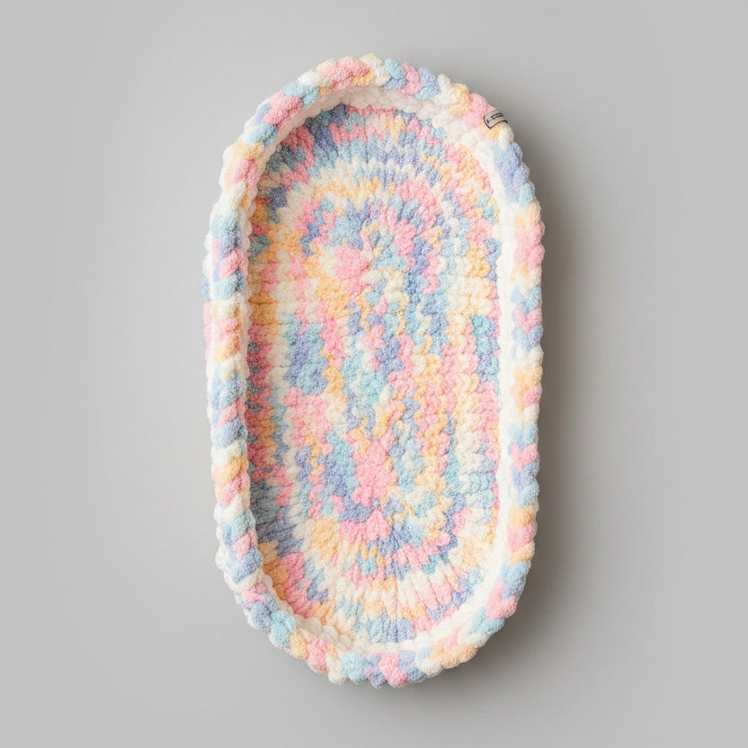 A photo of a bassinet mat with unicorn coloring